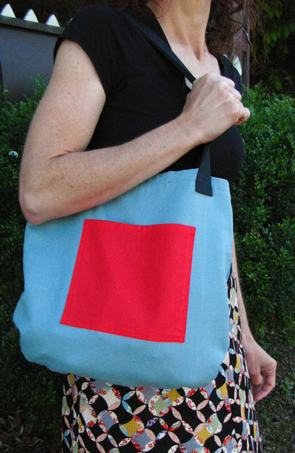 Blue tote bag with red pocket